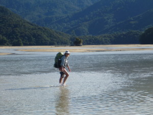 Helen crosses the estuary at Awaroa